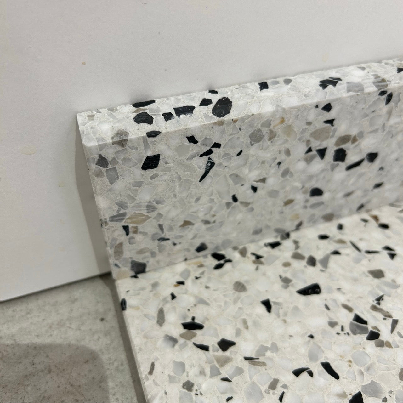 Terrazzo 1910 med sort, hvidt og gråbrunt mix Sokkelkant